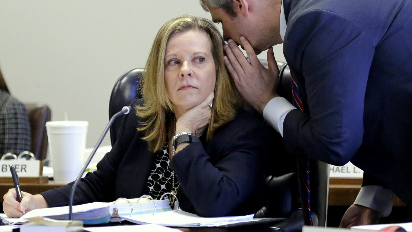 Texas Board of Education Chair Donna Bahorich, left, listens to Texas Education Agency counsel Von Byer, right, during a meeing, Wednesday, Nov. 18, 2015, in Austin, Texas. Texas could allow university professors to fact-check textbooks approved for statewide use, after a ninth-grade world geography book referred to African slaves as "workers." (AP Photo/Eric Gay)