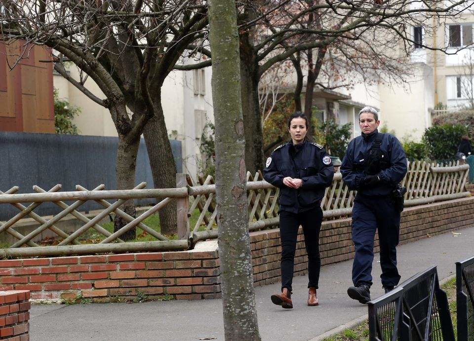 Police officers patrol near a Paris suburb Aubervilliers pre-school, after a masked assailant with a box-cutter and scissors who mentioned the Islamic State group attacked a teacher, Monday, Dec.14, 2015. The assailant remains at large, and the motive for the attack in the town of Aubervilliers is unclear, authorities said. (AP Photo/Michel Euler)