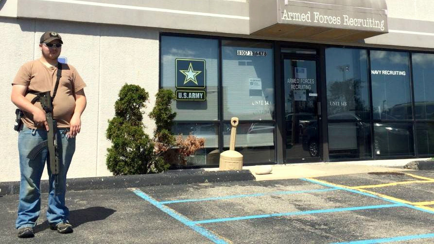 A member of the Genesee County Volunteer Militia group, stands outside an army recruiting center off in Flint Township. The militia intends to Join Michael Moore to protest the Flint water crisis. (Photo: Mlive)