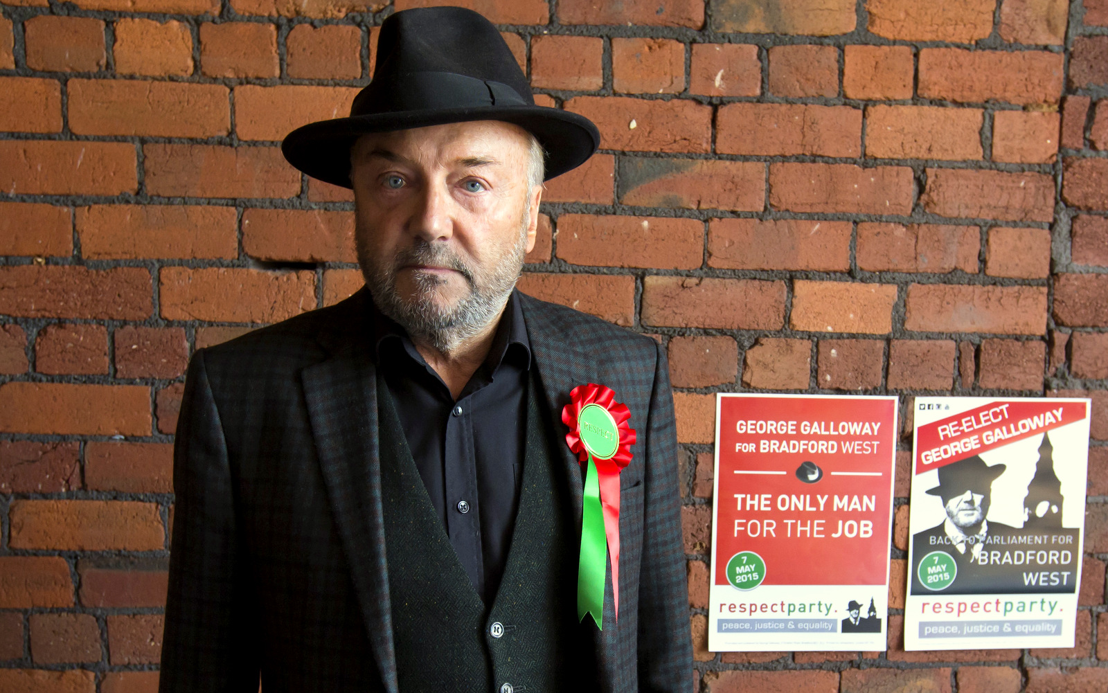Respect Party Leader George Galloway poses for a picture after an interview at his offices in the constituency of Bradford West, in Bradford, England. (AP Photo/Jon Super)