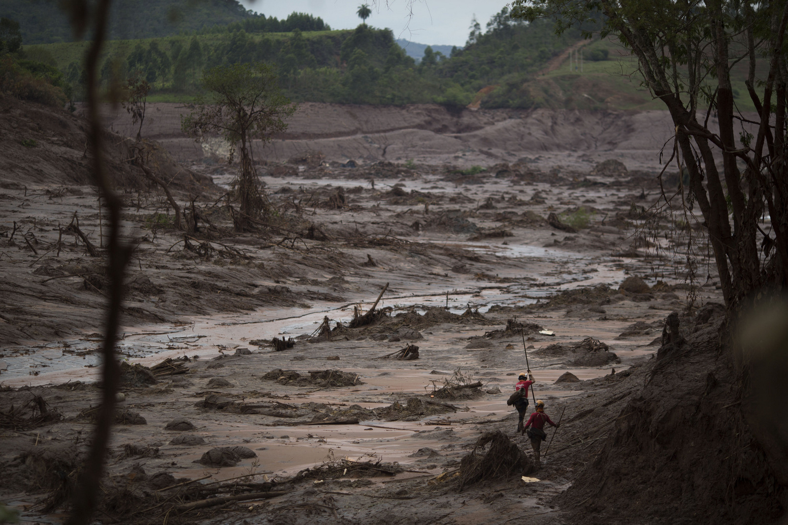 Rescue workers search for victims at the site where the town of Bento Rodrigues stood, after two dams burst in Minas Gerais state, Brazil, Nov. 8, 2015. (AP Photo/Felipe Dana)