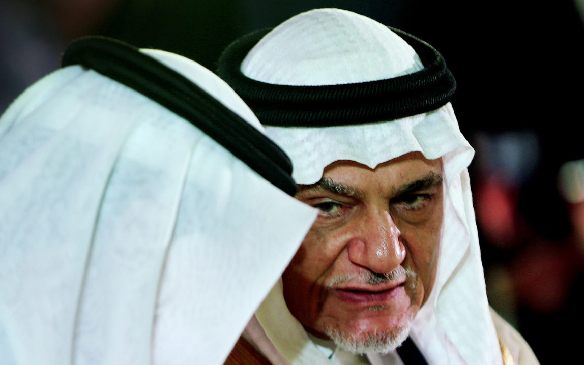 In this Saturday, Oct. 10, 2015 photo, Prince Turki al-Faisal talks with one of the dignitaries during the opening day of the Beirut Institute Summit in Abu Dhabi, United Arab Emirates. (AP Photo/Kamran Jebreili)