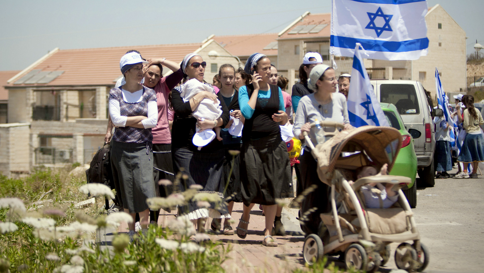Jewish settlers march during a demonstration against the proposed decision to evacuate a West Bank outpost in the Ulpana neighborhood, in the West Bank settlement of Beit El near the Palestinians city of Ramallah. (AP/Ariel Schalit)