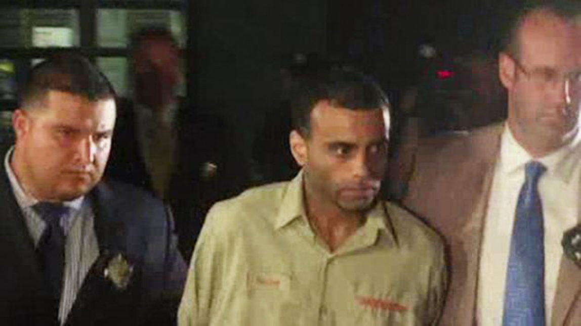 In this video image provided by WABC-TV, New York police officers walk with Oscar Morel, center, of Brooklyn, in New York on Monday, Aug. 16, 2016. Police arrested and charged Morel with murder late Monday night in the brazen daytime shooting deaths of an imam and his friend as they left a New York City mosque. (WABC-TV via AP)