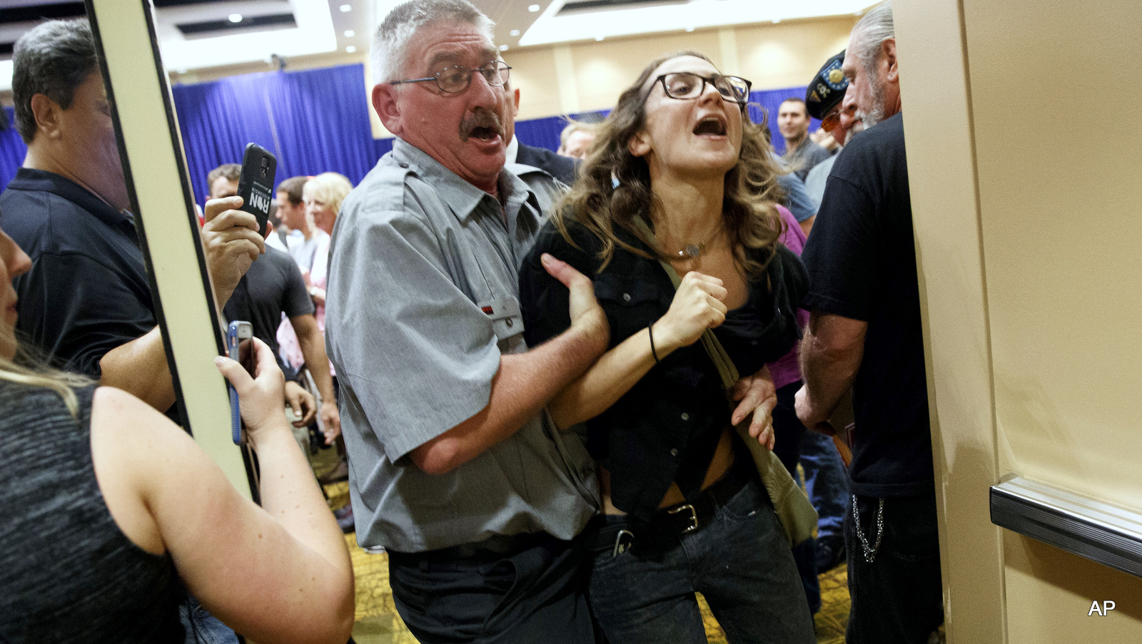 A demonstrator is removed during a campaign rally for Republican presidential candidate Donald Trump, Monday, Oct. 17, 2016, in Green Bay, Wis.