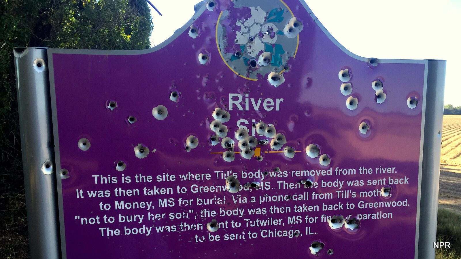 Bullet holes riddle the historical marker at the site where Emmett Till’s body was pulled from the Tallahatchie River in the rural Mississippi Delta.