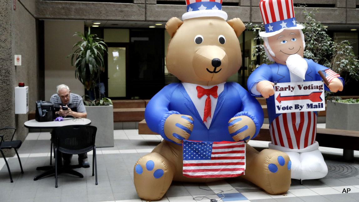 Inflatable figures direct voters at the Santa Clara County Registrar of Voters, Oct. 24, 2016, in San Jose, Calif.