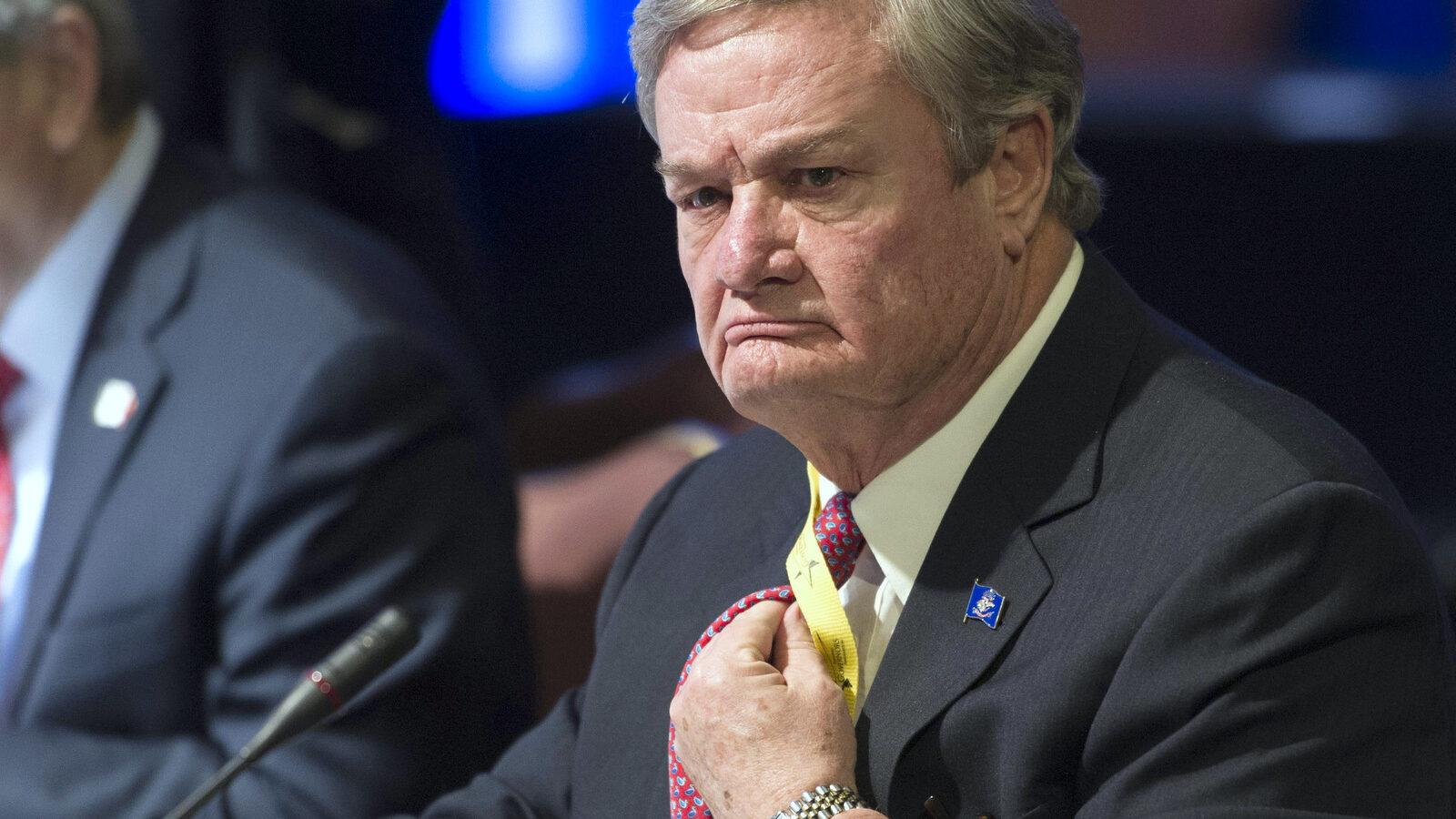 North Dakota Republican Gov. Jack Dalrymple adjusts his tie during a meeting in Washington. Feb. 21, 2015. (AP Photo/Cliff Owen, File)