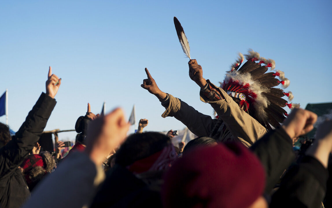 A crowd gathers in celebration at the Oceti Sakowin camp after it was announced that the U.S. Army Corps of Engineers won't grant easement for the Dakota Access oil pipeline in Cannon Ball, N.D., Sunday, Dec. 4, 2016. (AP Photo/David Goldman)