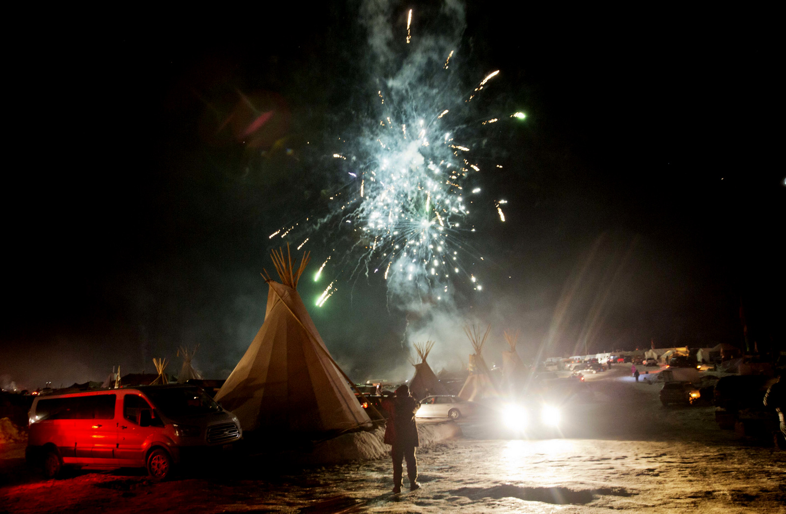 Fireworks go off over the Oceti Sakowin camp where people have gathered to protest the Dakota Access oil pipeline in Cannon Ball, N.D., Sunday, Dec. 4, 2016. U.S. Army Corps of Engineers spokeswoman Moria Kelley said in a news release Sunday that the administration will not allow the four-state, $3.8 billion pipeline to be built under Lake Oahe, a Missouri River reservoir where construction had been on hold. (AP Photo/David Goldman)