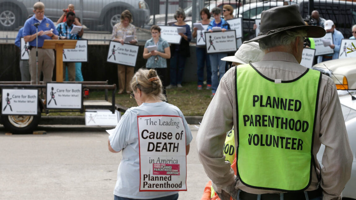 Planned Parenthood volunteers keep watch over anti-abortion protesters outside Planned Parenthood Wednesday, March 2, 2016, in Houston. (Photo: Pat Sullivan/AP)