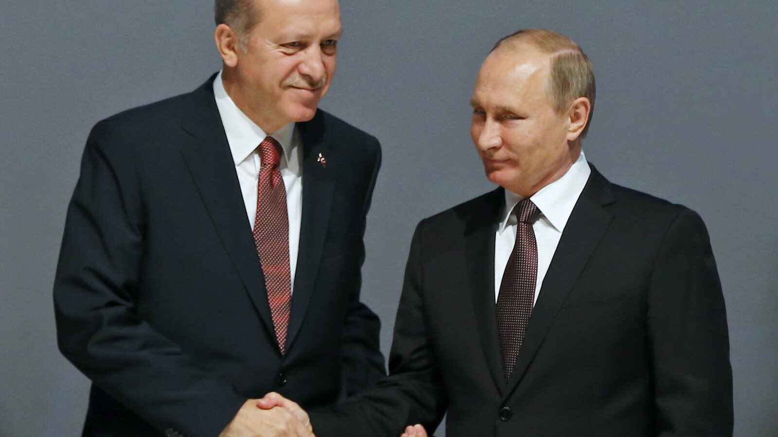 In this Oct. 10, 2016 photo, Turkey's President Recep Tayyip Erdogan, left and Russian President Vladimir Putin, shake hands following the group photo at the World Energy Congress, in Istanbul, Turkey. (AP/Emrah Gurel, File)