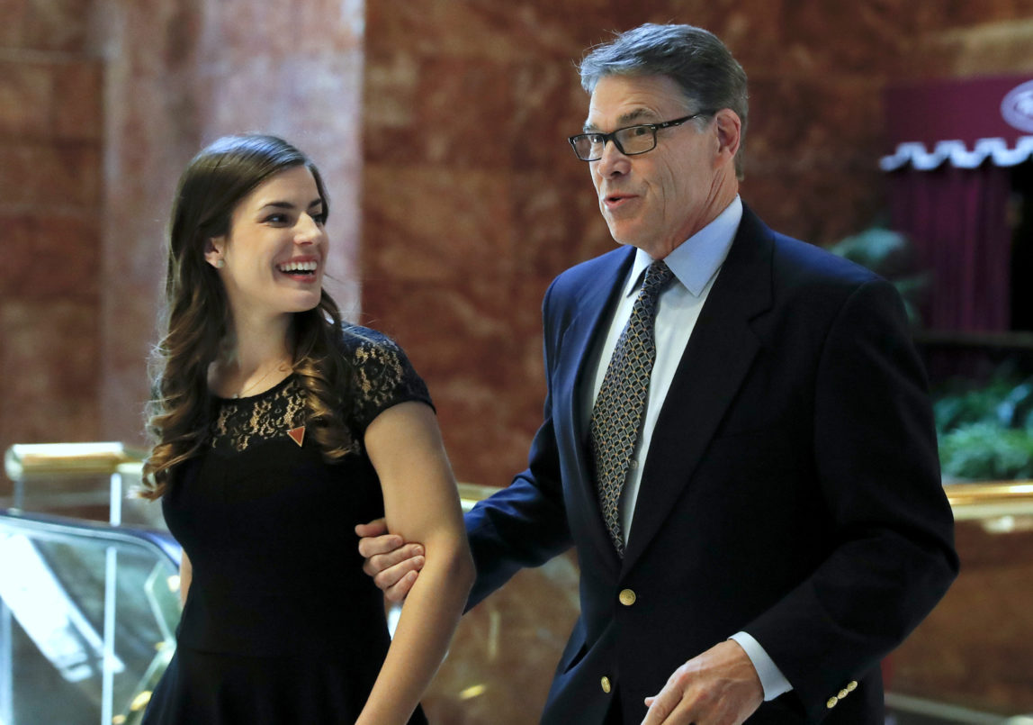 Former Texas Gov. Rick Perry, with Madeleine Westerhout of the Republican National Committee, arrives at Trump Tower, Monday, Nov. 21, 2016 in New York. AP/Carolyn Kaster)