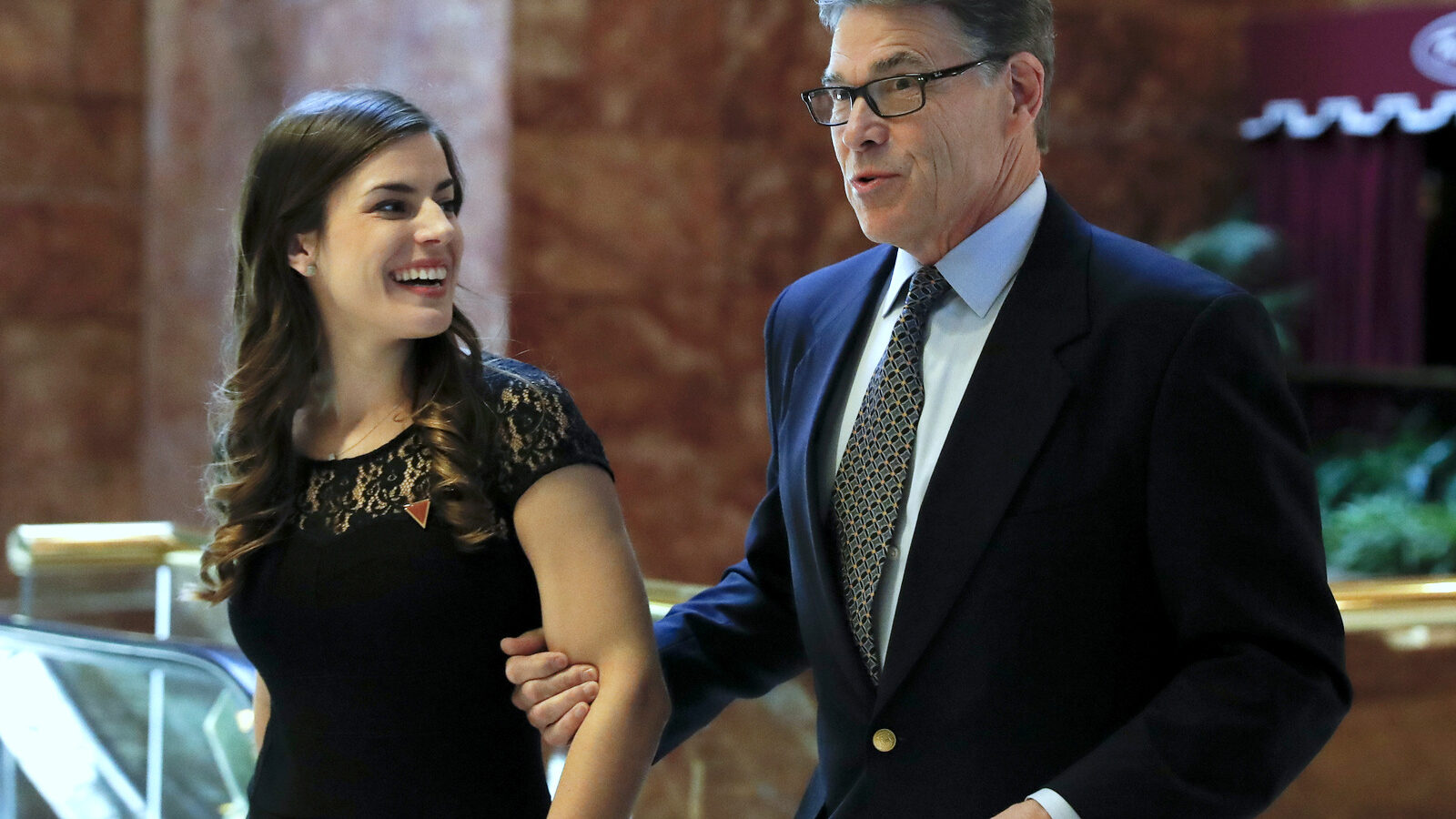 Former Texas Gov. Rick Perry, with Madeleine Westerhout of the Republican National Committee, arrives at Trump Tower, Monday, Nov. 21, 2016 in New York. AP/Carolyn Kaster)