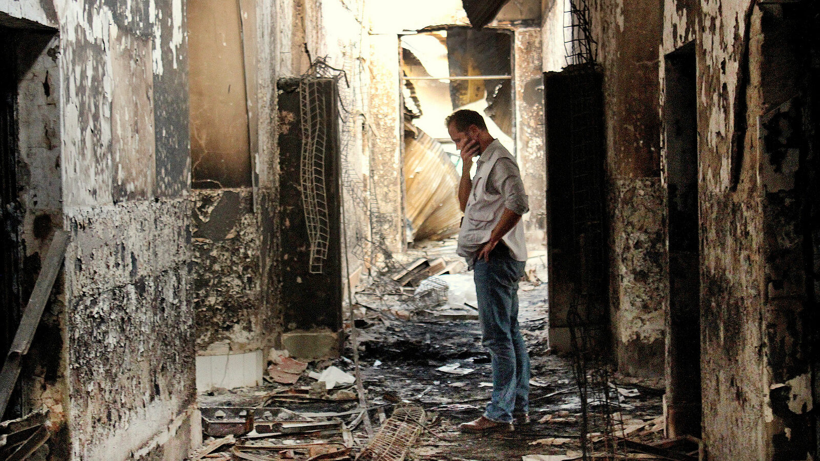 An employee of Doctors Without Borders, MSF, walks inside the charred remains of the organization's hospital after it was hit by a U.S. airstrike in Kunduz, Afghanistan. (AP/Najim Rahim)