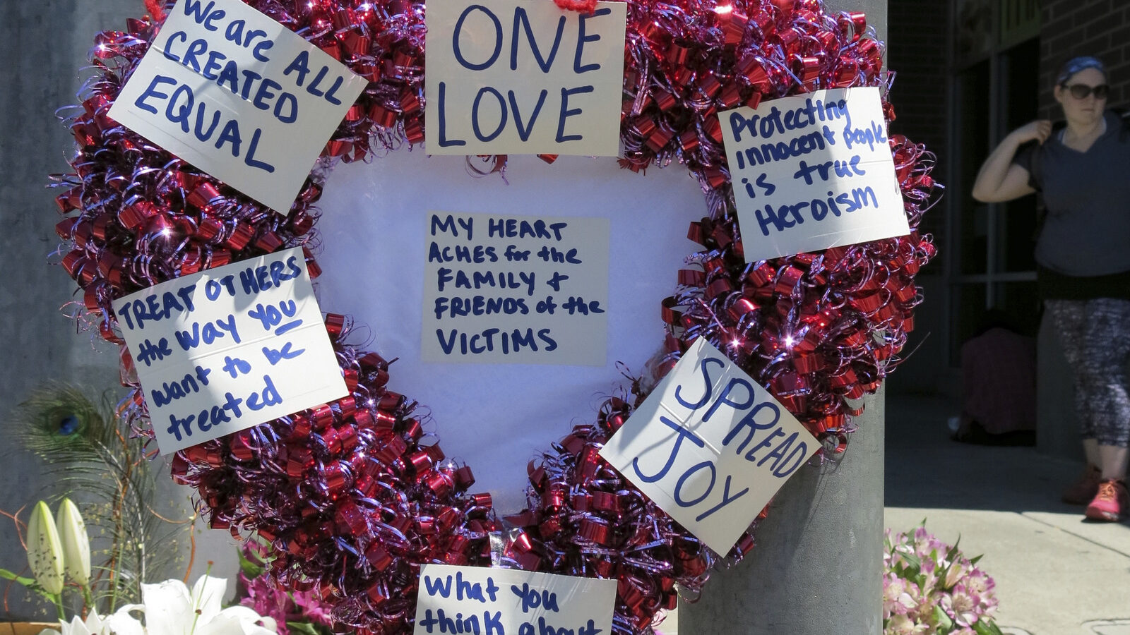 A wreath covered with positive messages hangs at a memorial for two bystanders who were stabbed to death Friday, while trying to stop a man who was yelling anti-Muslim slurs and acting aggressively toward two young women, including one wearing a hijab on a light-trail train in Portland, Ore, May 27, 2017. (AP Photo/Gillian Flaccus)