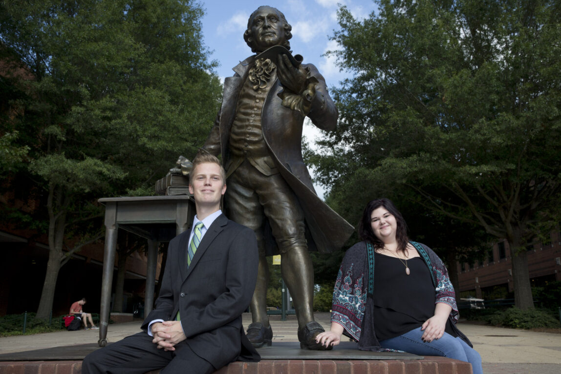 George Mason University students pose by the George Mason statue on campus in Fairfax, Va. George Mason University, a public school outside the nation's capital, has quietly become a conservative powerhouse in economics and law, a reputation built in part with tens of millions of dollars a year from billionaire Republican donor Charles Koch. (AP/Jacquelyn Martin)