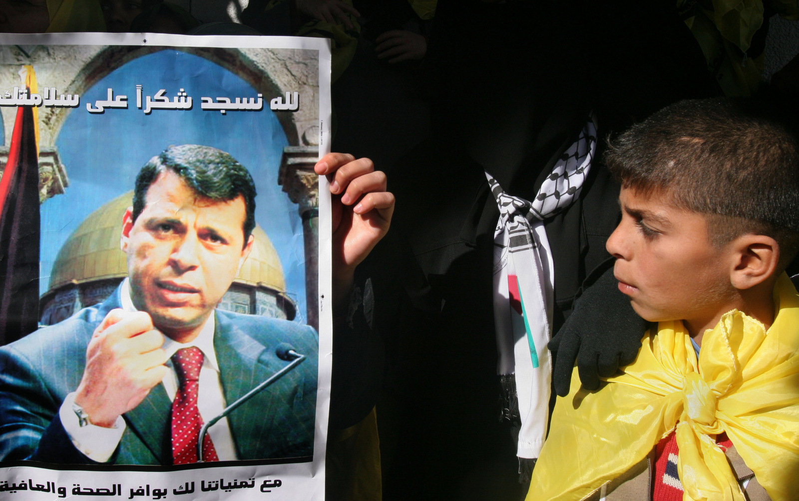 A Palestinian boy looks at a poster of Fatah leader Mohammed Dahlan during a rally in support of him in Gaza City, Dec. 16, 2006. (AP/Hatem Moussa)