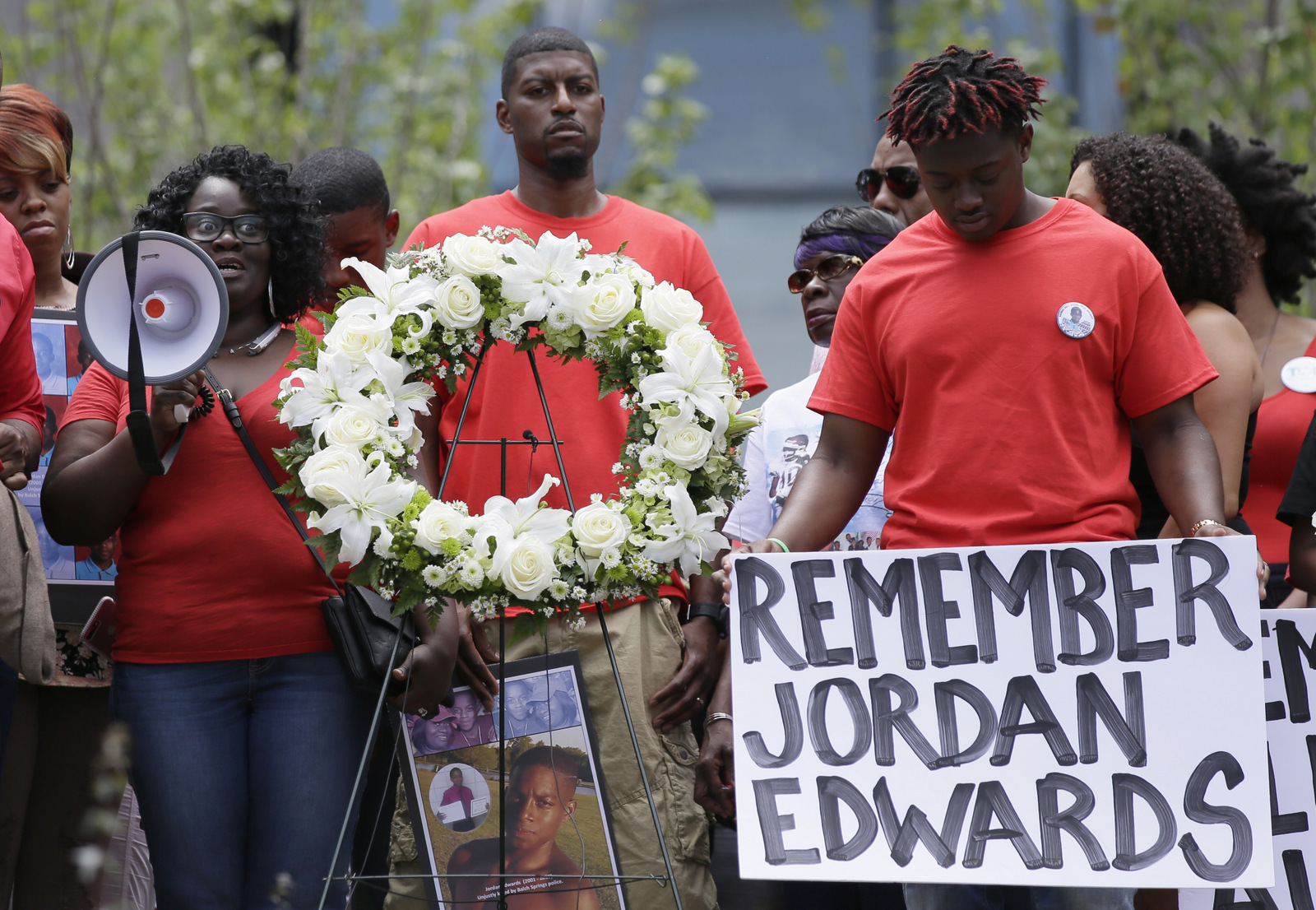 Slain teen Jordan Edwards' mother Charmaine Edwards, left, speaks to supporters with son Vidal Allen, right, and husband Odell Edwards during a protest outside the court house in Dallas.(AP/LM Otero)