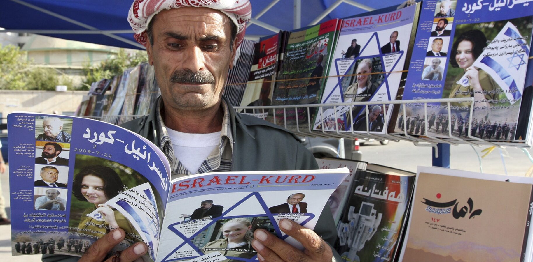 An Iraqi Kurd reads a copy of the magazine Israel-Kurd on a street in Irbil, Iraq in 2009. (Azad Lashkari/Reuters)