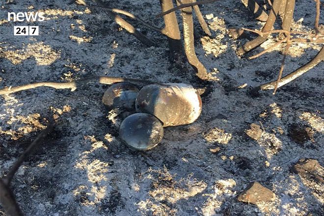 Two convex lenses placed next to a large canister of natural gas found near Kalamos, a suburb of