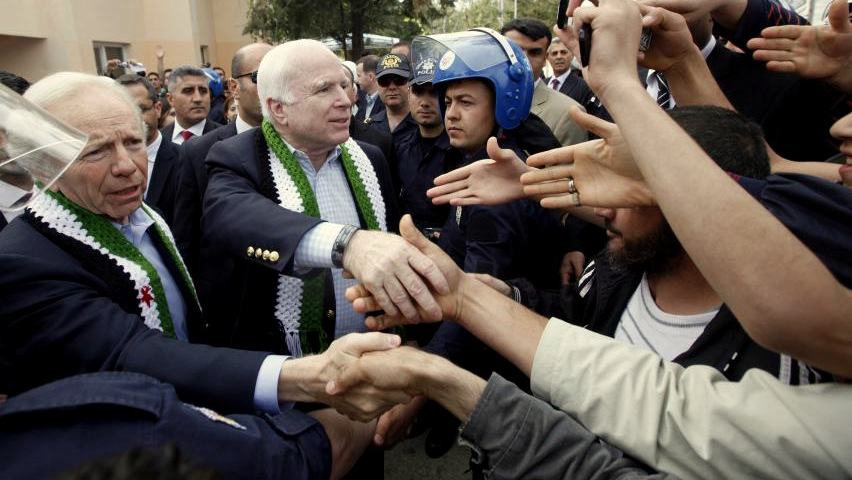 U.S. Senators John McCain (R-AZ) and Joseph Lieberman (D-CT) greet men at a refugee camp during a visit to the Turkish-Syrian border April 10, 2012. Umit Bektas | Reuters