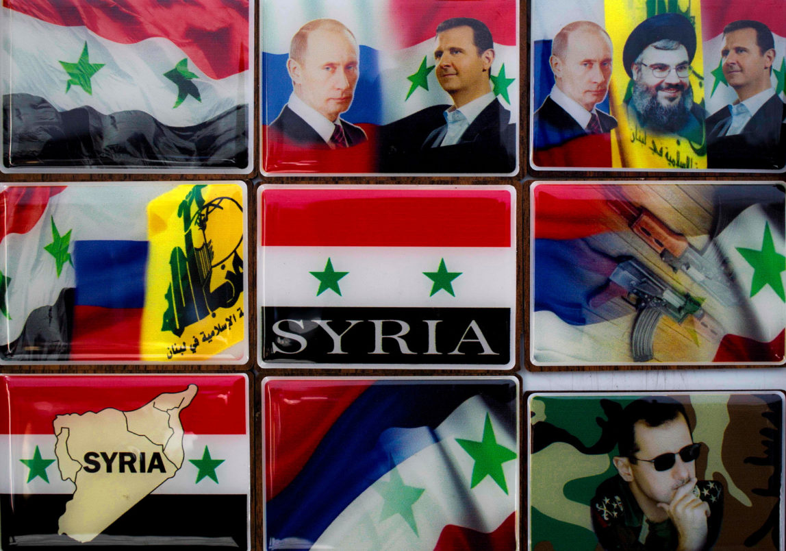 In this Sunday, April 17, 2016 photo, fridge magnets with pictures of Russian President Vladimir Putin, Syrian President Bashar Assad, Hezbollah leader Sheikh Hassan Nasrallah and the Russian, Syrian and Hezbollah national flags are displayed in a souvenirs shop outside the historic 7th century Umayyad Mosque, in Damascus, Syria. (AP/Hassan Ammar)