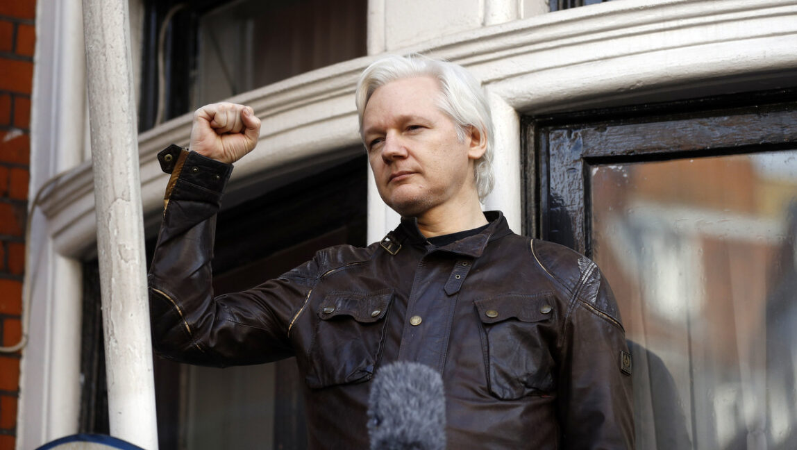 Julian Assange greets supporters outside the Ecuadorian embassy in London, Friday May 19, 2017. Sweden's top prosecutor says she is dropping an investigation into a rape claim against WikiLeaks founder Julian Assange after almost seven years. Assange took refuge in Ecuador's embassy in London in 2012 to escape extradition to Sweden to answer questions about sex-crime allegations from two women. (AP Photo/Frank Augstein)