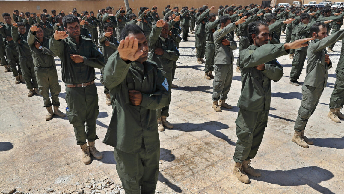 Syrian Internal Security Forces are sworn in during their graduation ceremony, at Ain Issa desert base, in Raqqa province, northeast Syria, Thursday, July 20, 2017. (AP Photo/Hussein Malla)