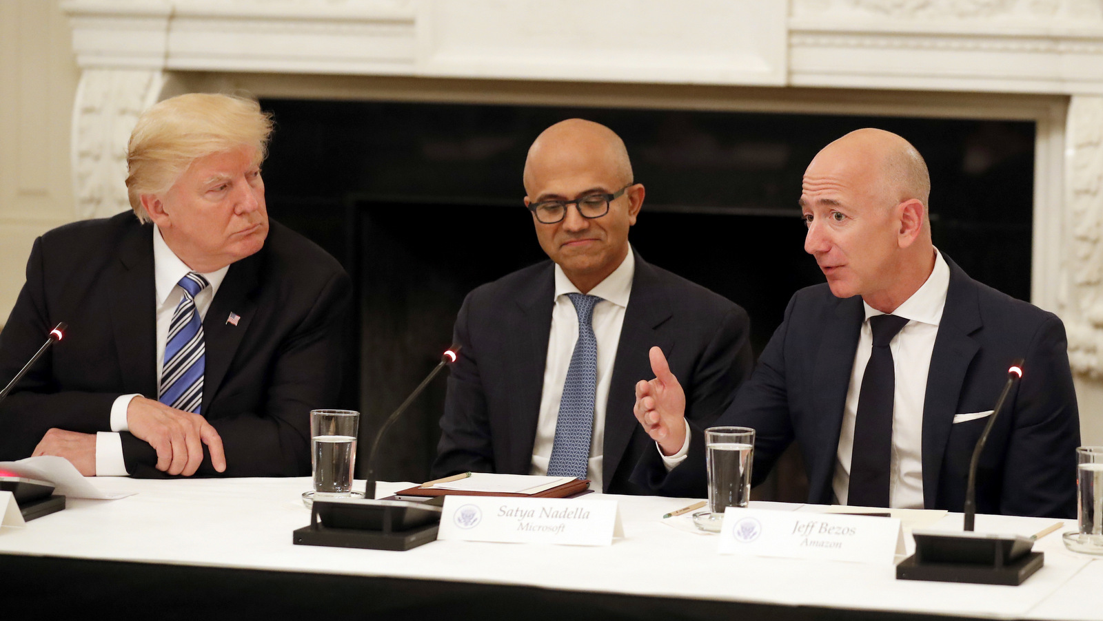 President Donald Trump, left, and Satya Nadella, Chief Executive Officer of Microsoft, center, listen as Jeff Bezos, Chief Executive Officer of Amazon, speaks during an American Technology Council roundtable in the State Dinning Room of the White House, June 19, 2017, in Washington. (AP/Alex Brandon)