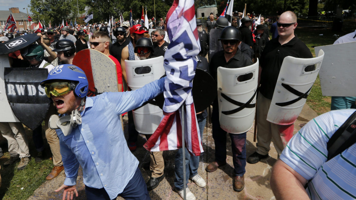 This Saturday, Aug. 12, 2017 image shows white supremacist yelling at counter demonstrators st the entrance to Emancipation Park in Charlottesville, Va. (AP/Steve Helber)