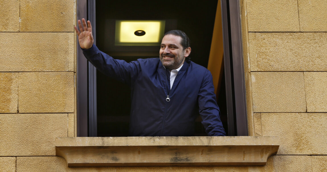 Lebanese Prime Minister Saad Hariri waves to his supporters from a window of his residence, in Beirut, Lebanon, Nov. 22, 2017. (AP/Bilal Hussein)