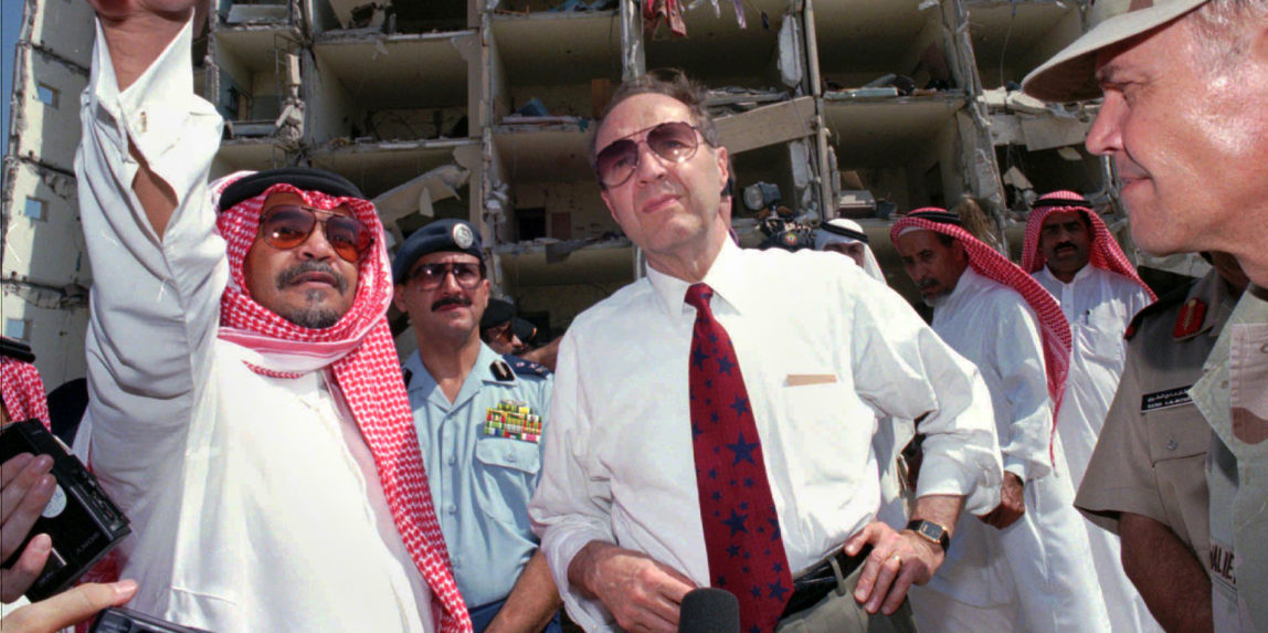 Defense Secretary William Perry, center, listens to then Saudi ambassador to the United States, Prince Bandar bin Sultan, left, at the blast site of the devastated Khobar Towers at a U.S. military base that killed 19 U.S. servicemen in Dhahran, Suadi Arabia. (AP/Saleh Rifai)