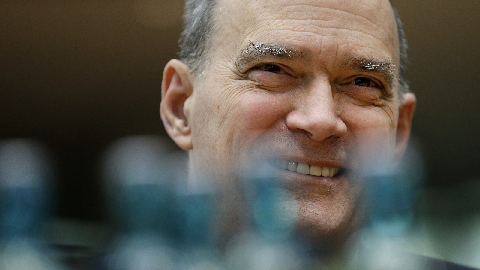 The former US National Security Agency, NSA, employee William Binney smiles behind water bottles as he waits for his questioning by the German parliamentary NSA investigation committee in Berlin, Germany, July 3, 2014. (AP/Michael Sohn)