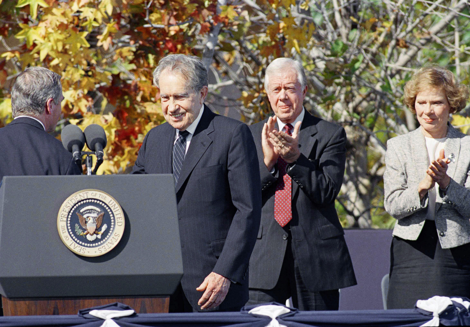Former President Jimmy Carter applauds former President Richard M. Nixon as he is introduced at the dedication ceremony for the Ronald Reagan Presidential Library in Simi Valley, California Monday, Nov. 4, 1991. The gathering was the first ever by five U.S. Presidents. (AP/Craig Fujii)