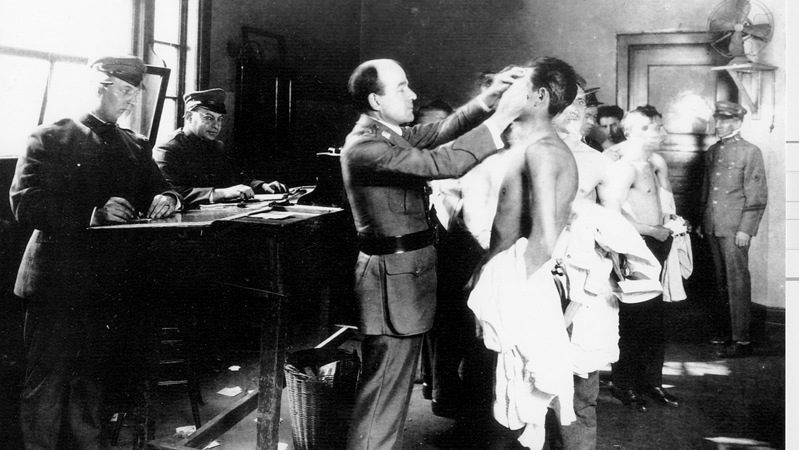 Health inspectors examine detainees on Angel Island, California. 1917. (Photo: National Archives)