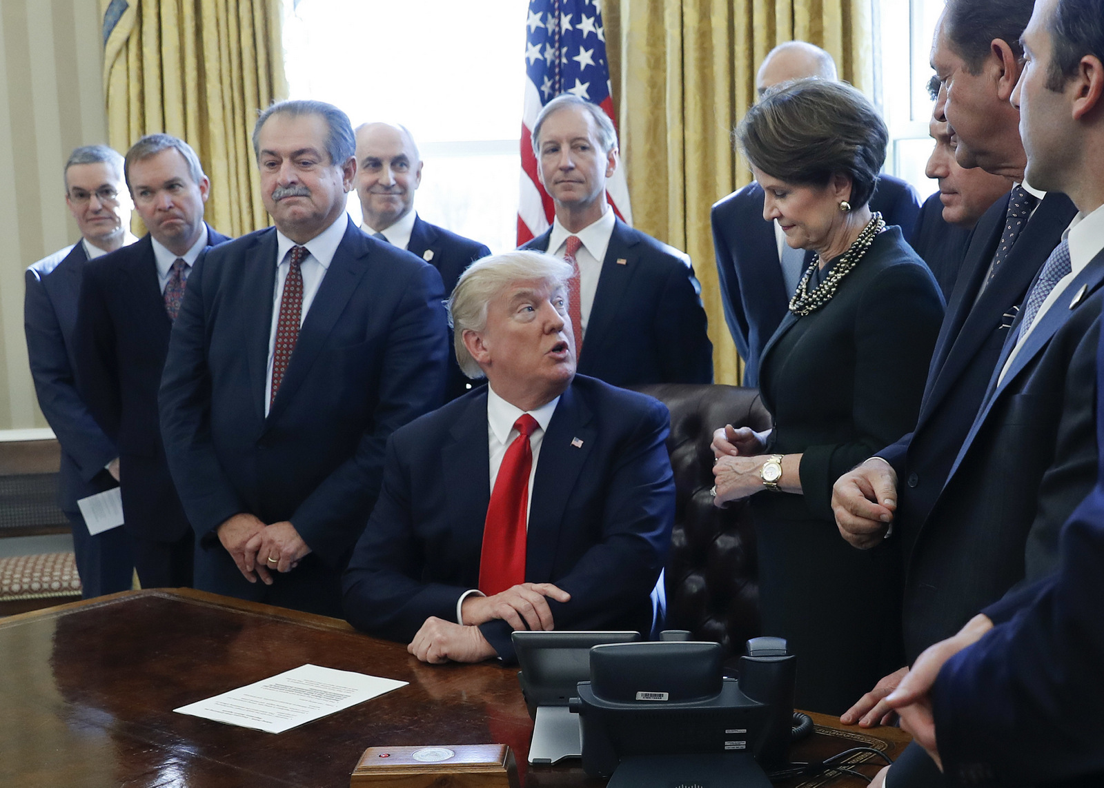 President Donald Trump looks over to Lockheed Martin Chairwoman, President and CEO Marillyn Hewson, right, before signing an executive order in the Oval Office of the White House in Washington, Feb. 24, 2017.(AP/Pablo Martinez Monsivais)