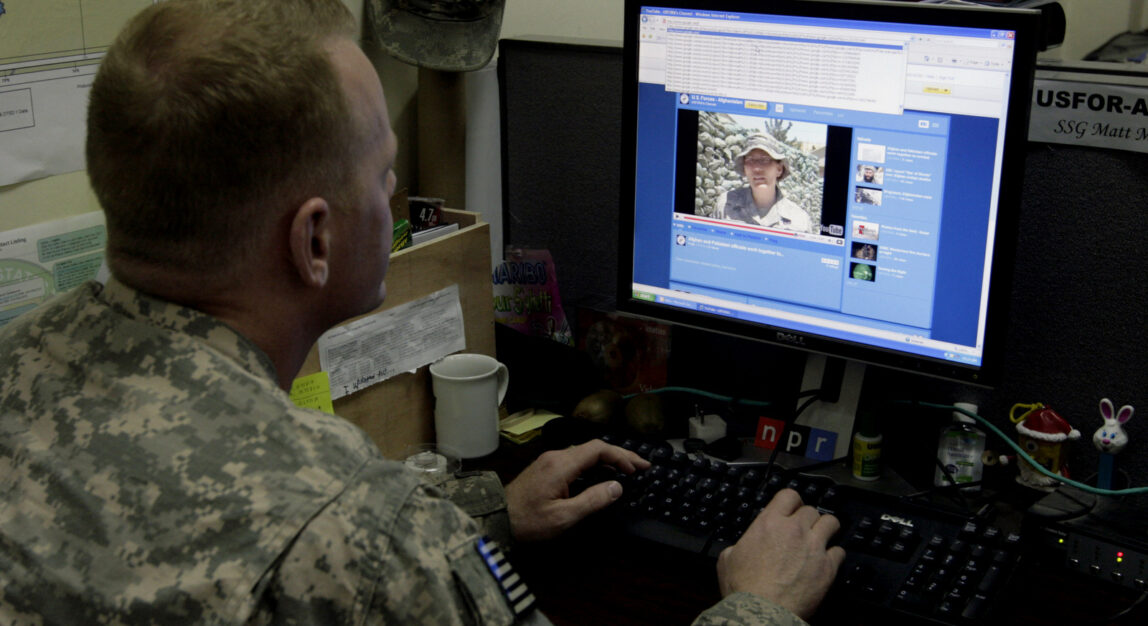 Army Staff Sgt. Matthew Millham, 31, from New Paltz, N.Y., a former reporter for the military newspaper Stars and Stripes, checks a Facebook site in Kabul, Afghanistan as part of a new communications effort to reach a non-newspaper reading Internet audience. (AP/Musadeq Sadeq)