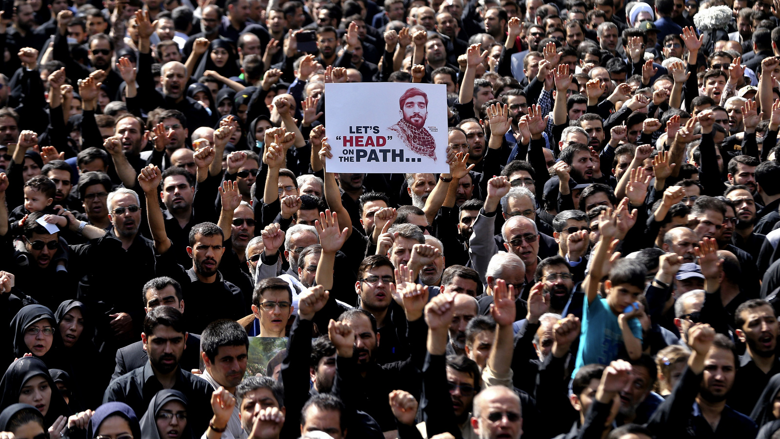 Thousands of Iranians attend the funeral of Mohsen Hojaji, an Iranian soldier beheaded by ISIS in Syria, in Tehran, Iran, Sept. 27, 2017.(AP/Ebrahim Noroozi)