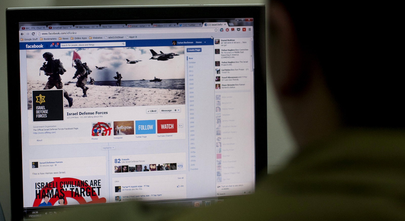 An Israeli soldier looks at the Facebook page of the IDF, at the IDF spokesperson office in Jerusalem, in the occupied territories. (AP/Sebastian Scheiner)
