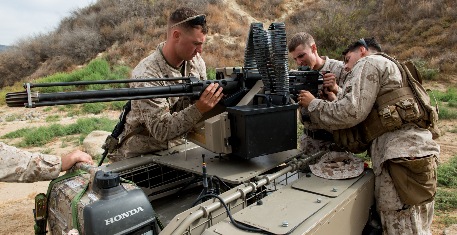 U.S. Marines adjust a mounted gun on the Multi Utility Tactical Transport (MUTT) for testing at Marine Corps Base Camp Pendleton, Calif., July 8, 2016. (U.S. Marine Corps photo)