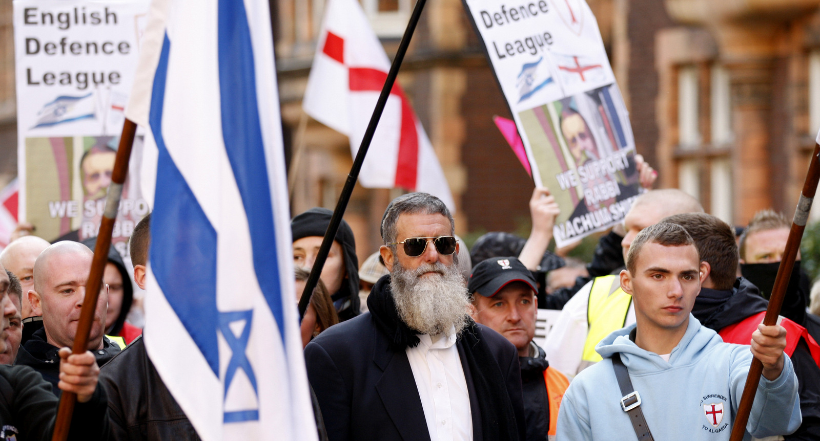 Rabbi Nachum Shifren, center, marches with white nationalist English Defence League (EDL) supporters to an EDL rally against what they claim is the Islamification of the UK and in support of Israel, outside the Israeli Embassy in London, Oct. 24, 2010. (AP/Sang Tan)