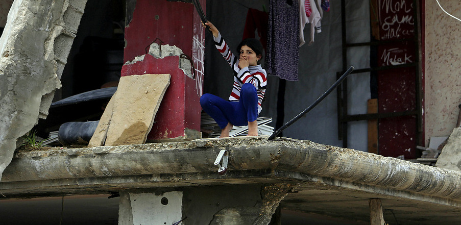A Palestinian girl sits inside a room of her family's home which was destroyed in Israel's 2014 bombing of Gaza, in the Shijaiyah neighborhood, Feb. 23, 2015. (AP/Adel Hana)