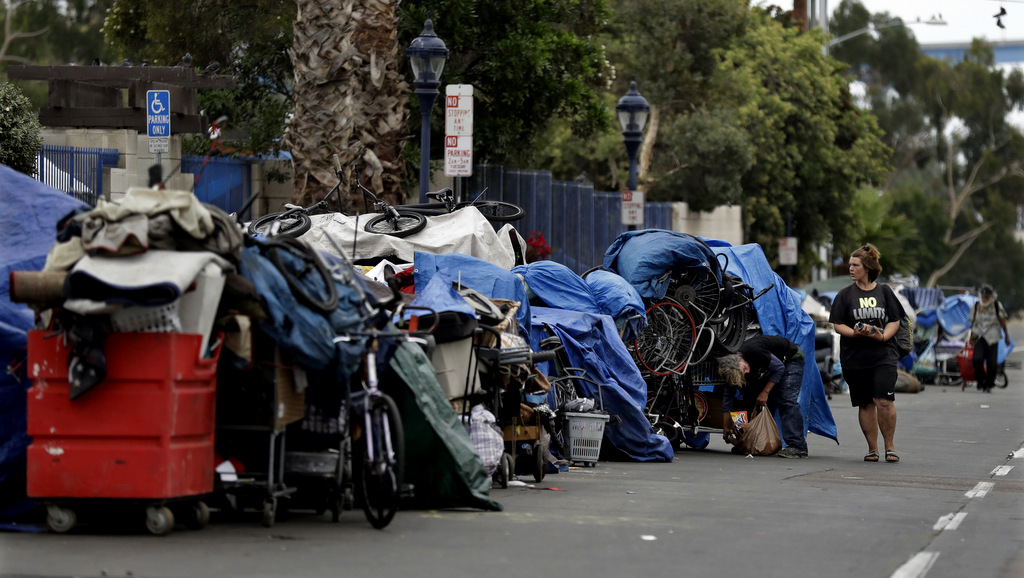 Trash from homeless encampments lines a street in San Diego. In a place that bills itself as “America’s Finest City,” renowned for its sunny weather, surfing and fish tacos, spiraling real estate values have contributed to spiraling homelessness in San Diego. Most alarmingly, the explosive growth in the number of people living outdoors has contributed to a hepatitis A epidemic, Sept. 19, 2017. (AP/Gregory Bull)