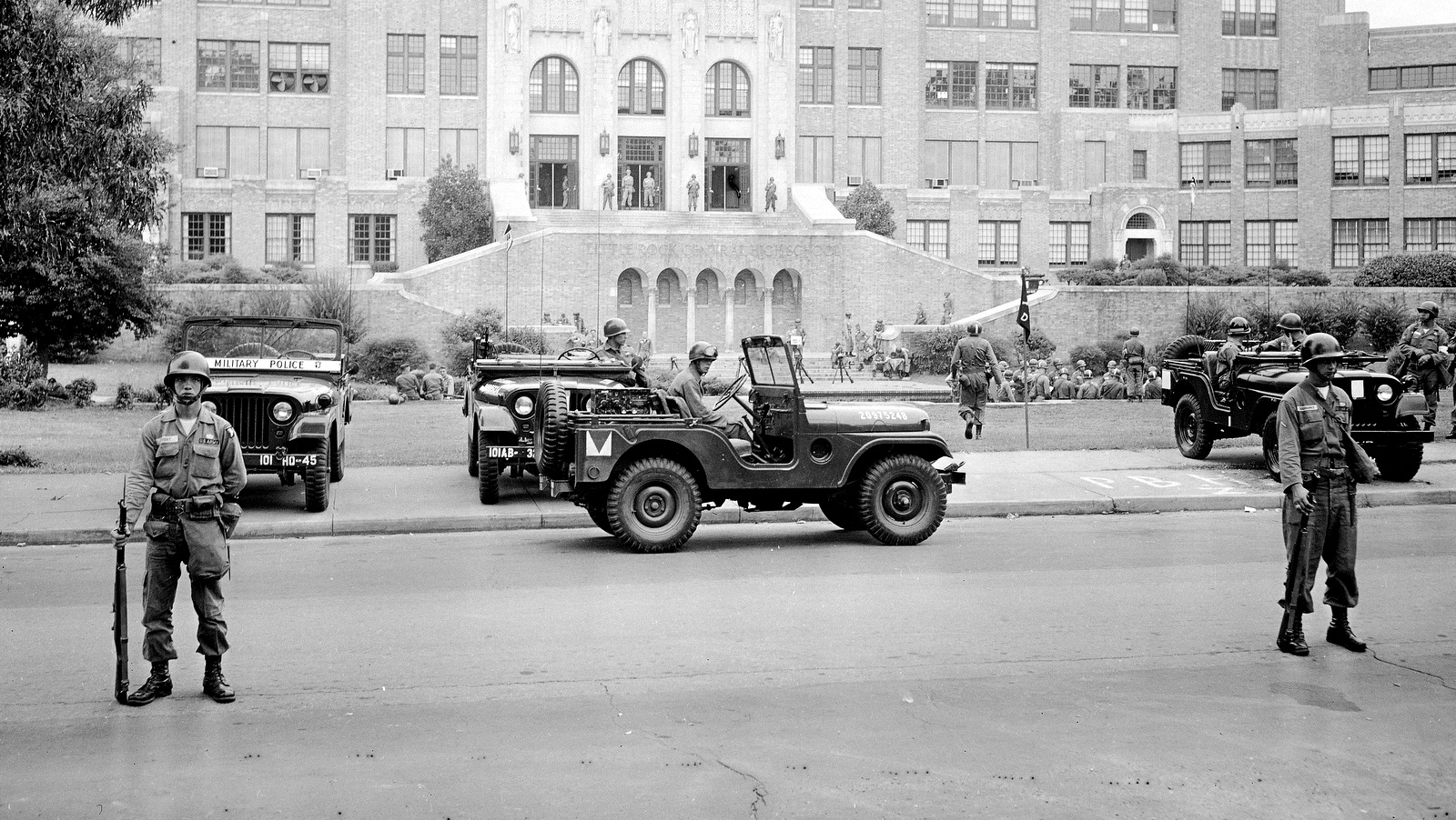 101st Airborne Division take up positions outside Central High School in Little Rock, Ark. The troopers are on duty to enforce integration at the school. Sept. 26, 1957. (AP Photo)