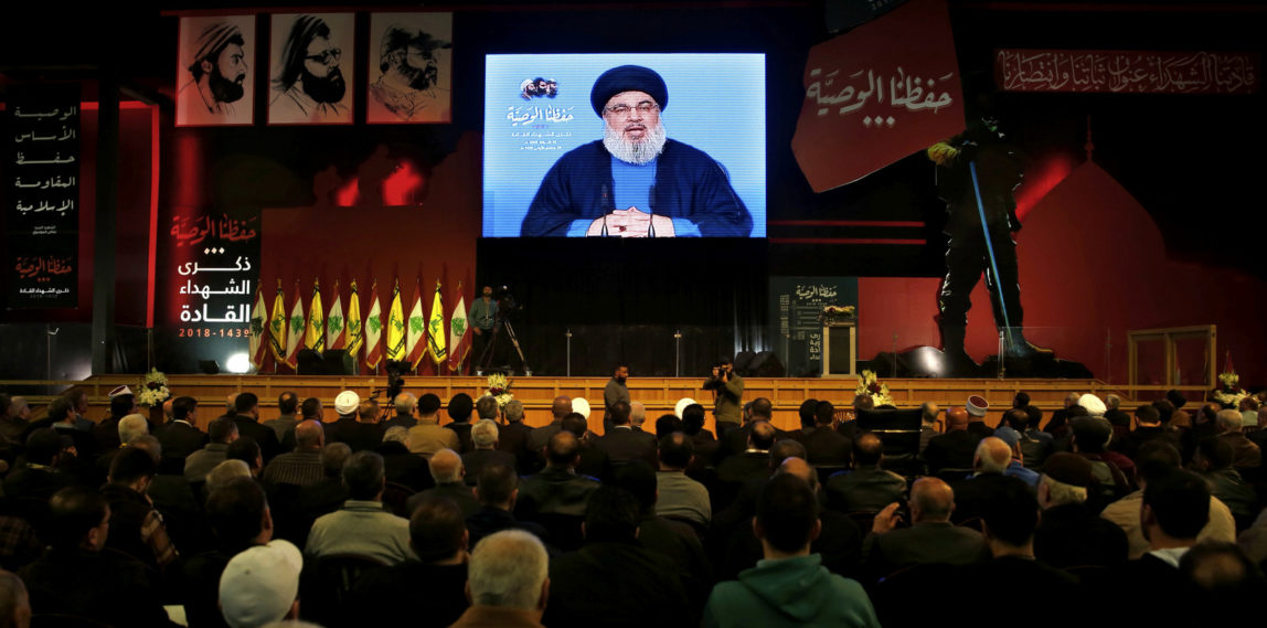 Hezbollah leader Sheik Hassan Nasrallah speaks on a screen via a video link during a ceremony to mark the anniversary of the death of Hezbollah leaders in the southern suburbs of Beirut, Lebanon, Feb. 16, 2018. (AP/Bilal Hussein)
