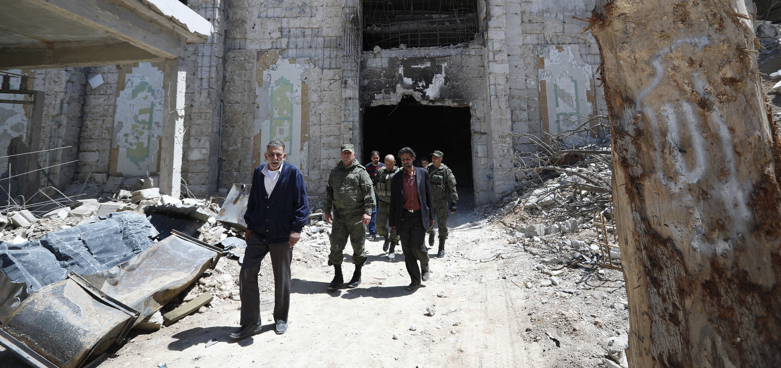 Russian military police officers check a weapons factory left Jaysh al-Islam, in the town of Douma, the site of a suspected chemical weapons attack, near Damascus, Syria, April 16, 2018. Faisal Mekdad, Syria's deputy foreign minister, said on Monday that his country is "fully ready" to cooperate with the fact-finding mission from the Organization for the Prohibition of Chemical Weapons that's in Syria to investigate the alleged chemical attack that triggered U.S.-led airstrikes. (AP/Hassan Ammar)