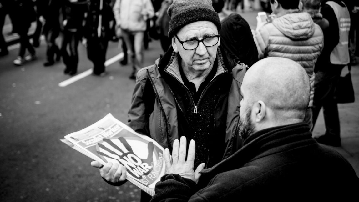Two men debate at the "stop bombing Syria" protest march on 12th December 2015, Regent Street, London.