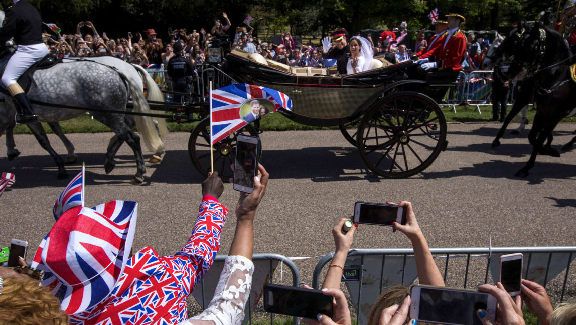 Britain's Prince Harry and Meghan Markle wave to the crowd in a carriage after their wedding ceremony at St. George's Chapel in Windsor Castle in Windsor, near London, England, May 19, 2018. (AP/Emilio Morenatti)