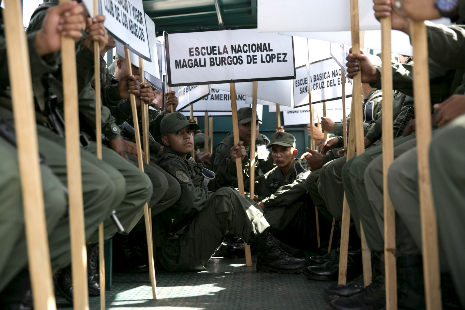 Soldiers hold signs of the names of schools that will serve as voting centers as they leave for those schools in Caracas, May 15, 2018. AP | Ariana Cubillos